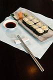 Sushi and rolls on the wooden plate