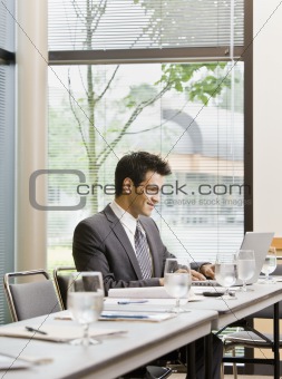 Man in Business Suit Smiling with laptop