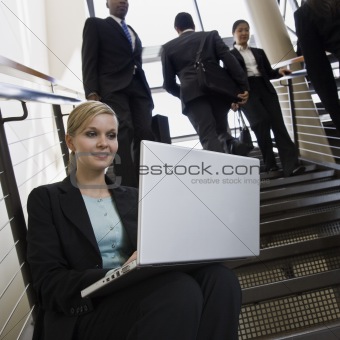 Businesswoman Sitting on Stairs