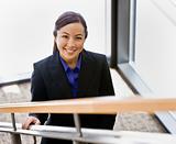Young Businesswoman on Stairs Smiling
