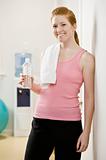 Young Woman Drinking Water After Exercising