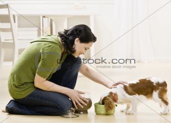 Woman Feeding Puppy
