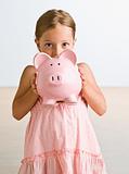 Girl holding piggy bank