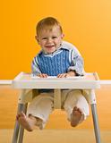 Young boy in highchair
