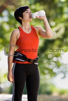 Runner drinking from water bottle