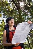 Woman with backpack looking at map