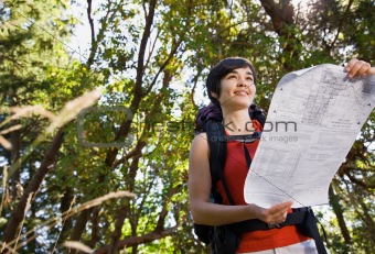 Woman with backpack looking at map