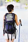 Woman hiking with backpack and walking stick