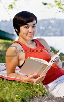 Woman reading book in park