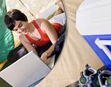 Woman using laptop in tent