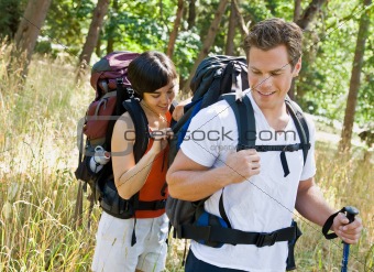 Woman opening boyfriends backpack
