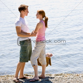 Couple having picnic near stream