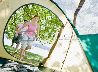 Couple running to tent