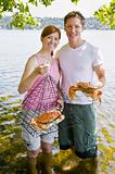 Couple holding crab and trap