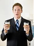 Businessman holding paper coffee cups