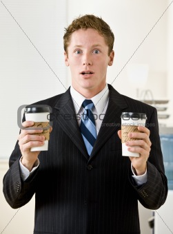 Businessman holding paper coffee cups