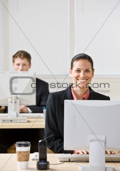 Business people typing on computers