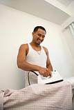 Smiling Young Man Ironing