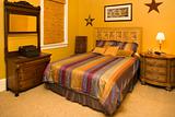 Bed With Striped Bedspread in Affluent Home
