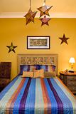 Bedroom Interior With Striped Bedspread and Decorative Stars