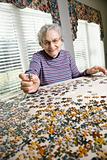 Elderly Woman Doing Jig Saw Puzzle