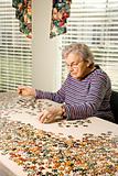 Elderly Woman Doing Jig Saw Puzzle