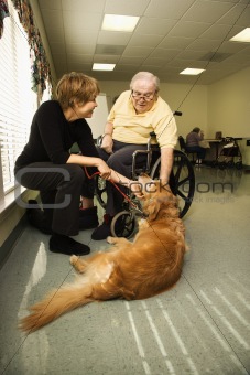 Elderly Man with Woman Petting Dog