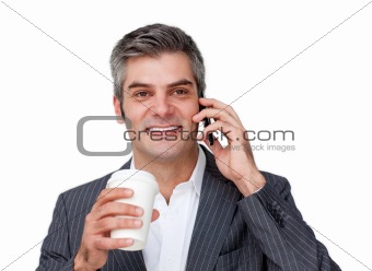 Confident Businessman on phone while drinking a coffee