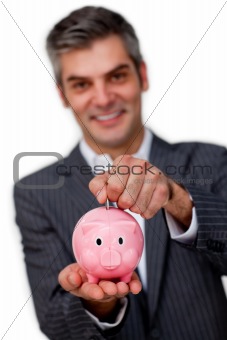 Businessman saving money in a piggybank 