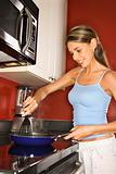 Attractive Young Woman in Kitchen Cooking