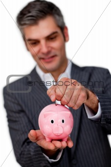 Sophisticated male executive saving money in a piggybank