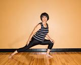 Woman Stretches Leg in Yoga Pose