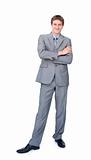 Smiling businessman standing with folded arms 