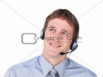Young businessmnan with headset on looking up 