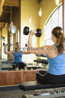 Woman Seated Lifting Weights