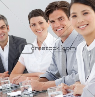 International business people sitting around a conference table