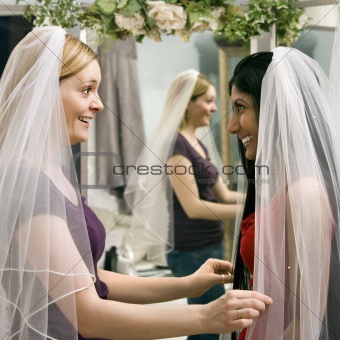Friends trying on veils.