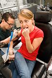 Woman getting tattoo.