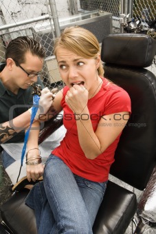 Woman getting tattoo.