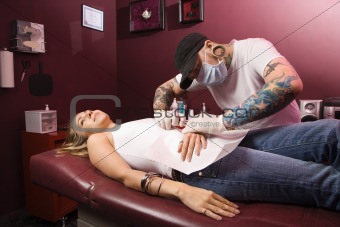 Woman getting pierced.