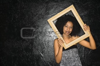 Woman holding frame.