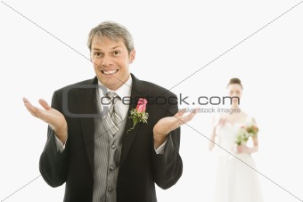 Groom with hands up.