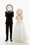 Bride and groom with clocks.