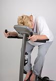 tired woman on exercise bike