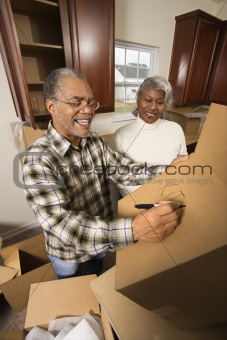 Middle-aged couple with moving boxes. 