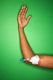 African-American female arm with bandage gauze and IV.