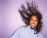 African-American man with his dreadlocks in motion.