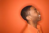 African-American man on orange background.