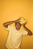 Man dropping bowl of lemons balancing on his head.