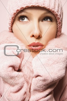 Caucasian woman wearing winter coat and hat.